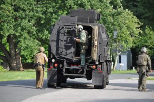 2016 07 15 Barricade on Wilson Road (4) Officers approaching residence with MRAP as cover